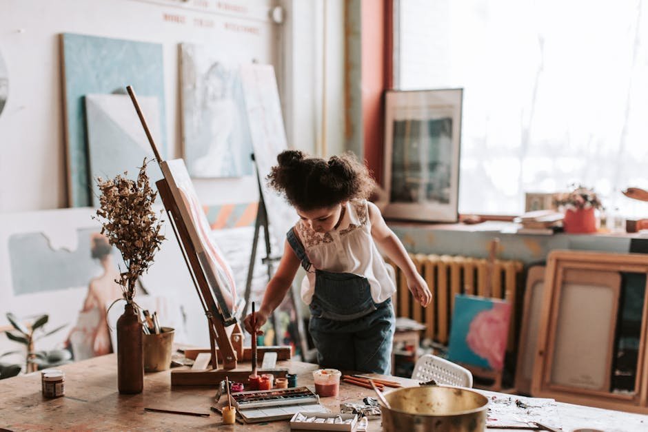 A child engaged in painting in an artistic studio, showcasing creativity and expression.