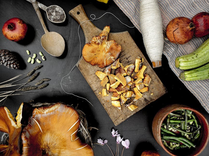 Artistic arrangement of fresh vegetables and mushrooms on a wooden board, showcasing a rustic still life setting.